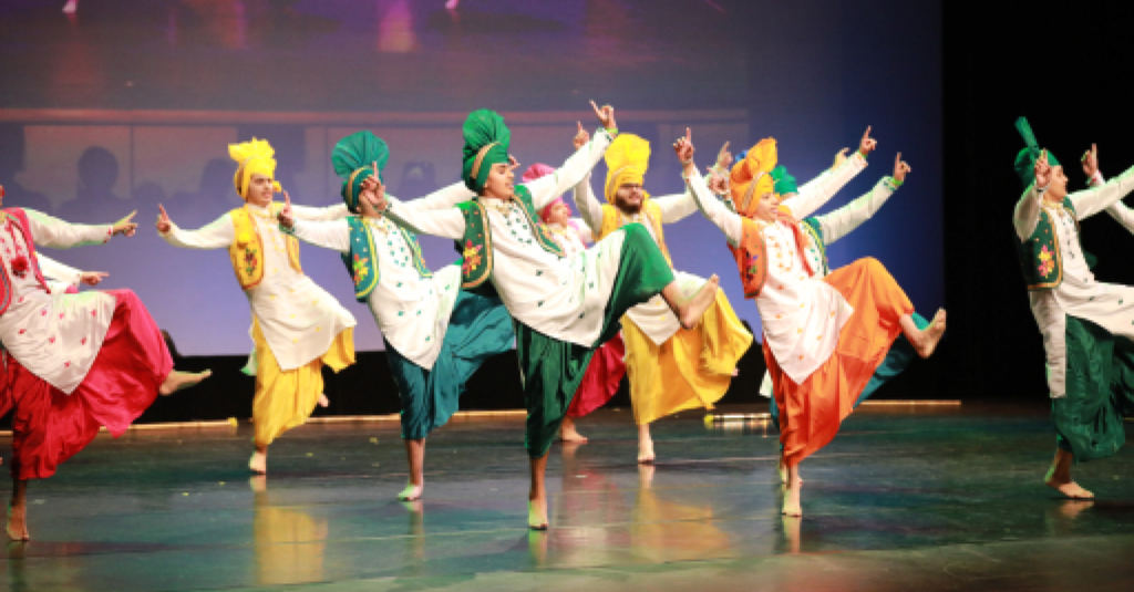 People performing Bhangra dance on stage